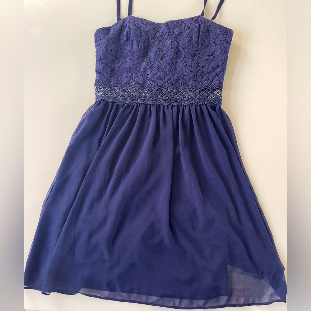 Dark blue mini dress. Top and skirt lined. Macrame midriff. Dressy.